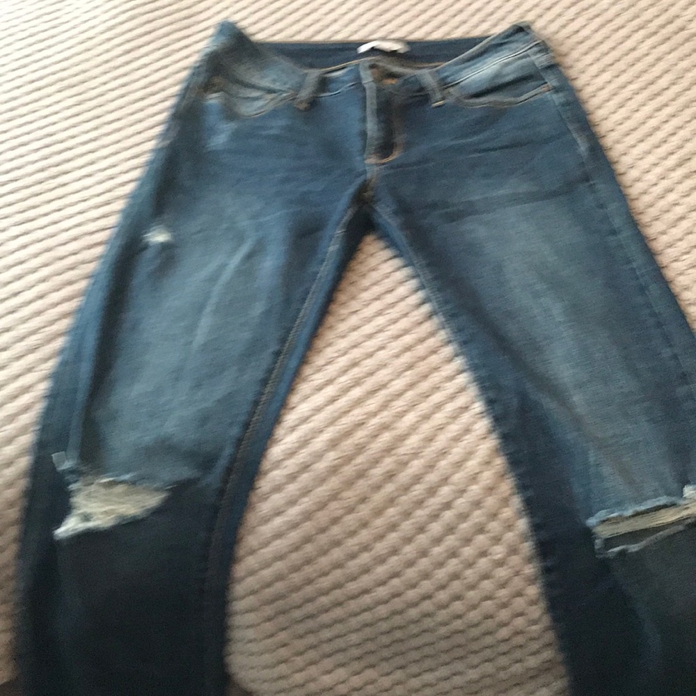 Stretchy, dark blue, boot cut , ripped jeans.